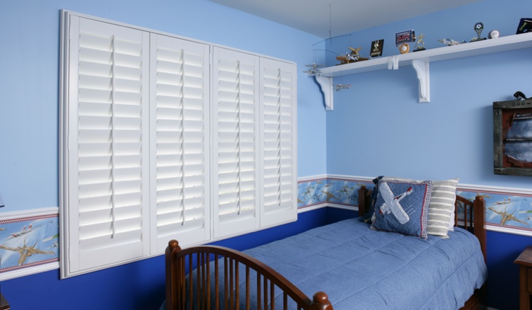 White plantation shutters in blue kids bedroom in Virginia Beach 